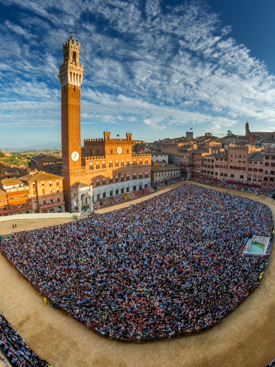 siena, piazza del campo full of people seen from the tower of palazzo sansedoni during the palio days